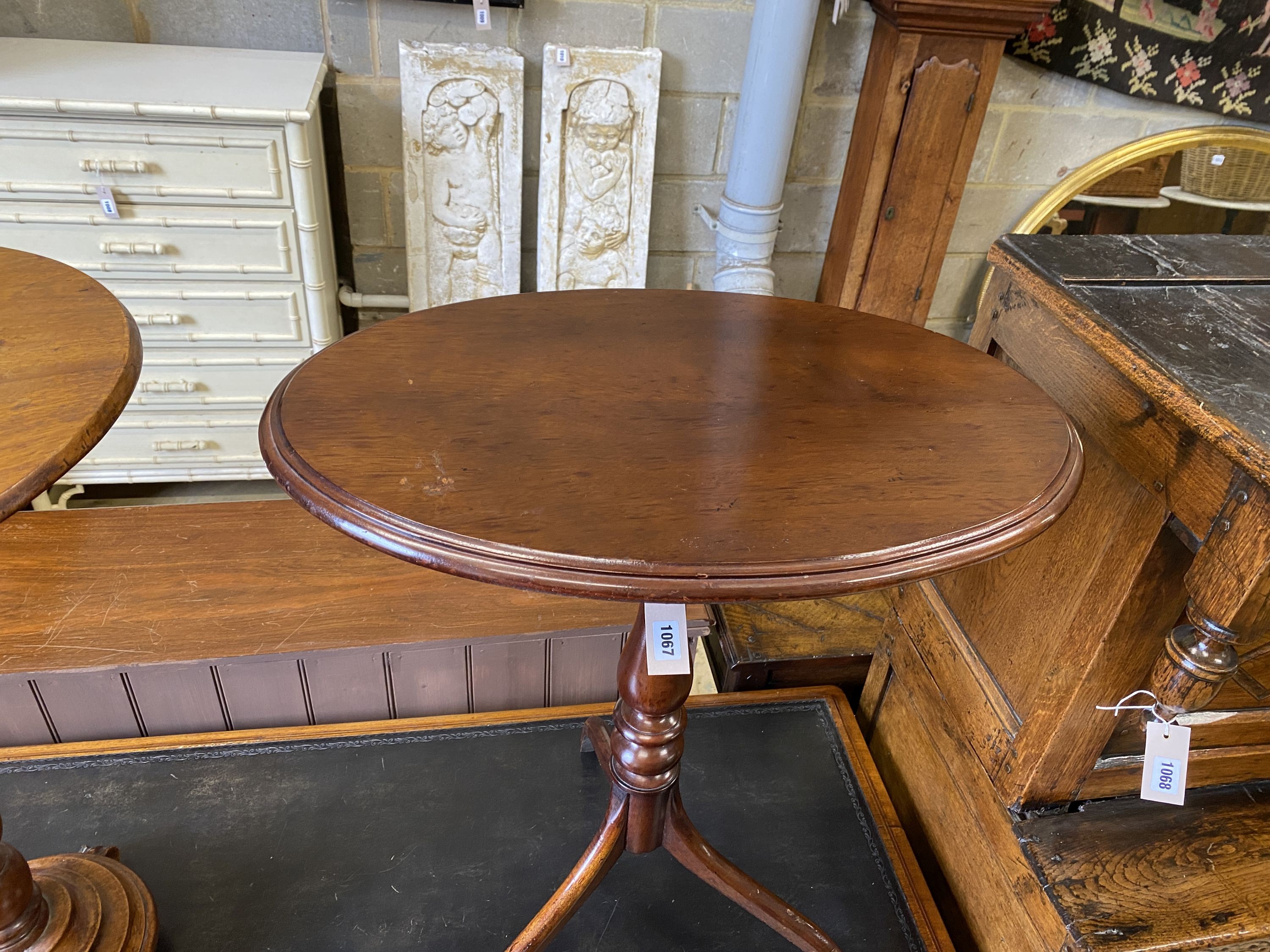 A Victorian circular mahogany wine table, diameter 50cm, height 76cm together with an oval tilt top tripod table